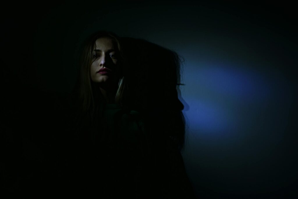 photo of woman in dark room