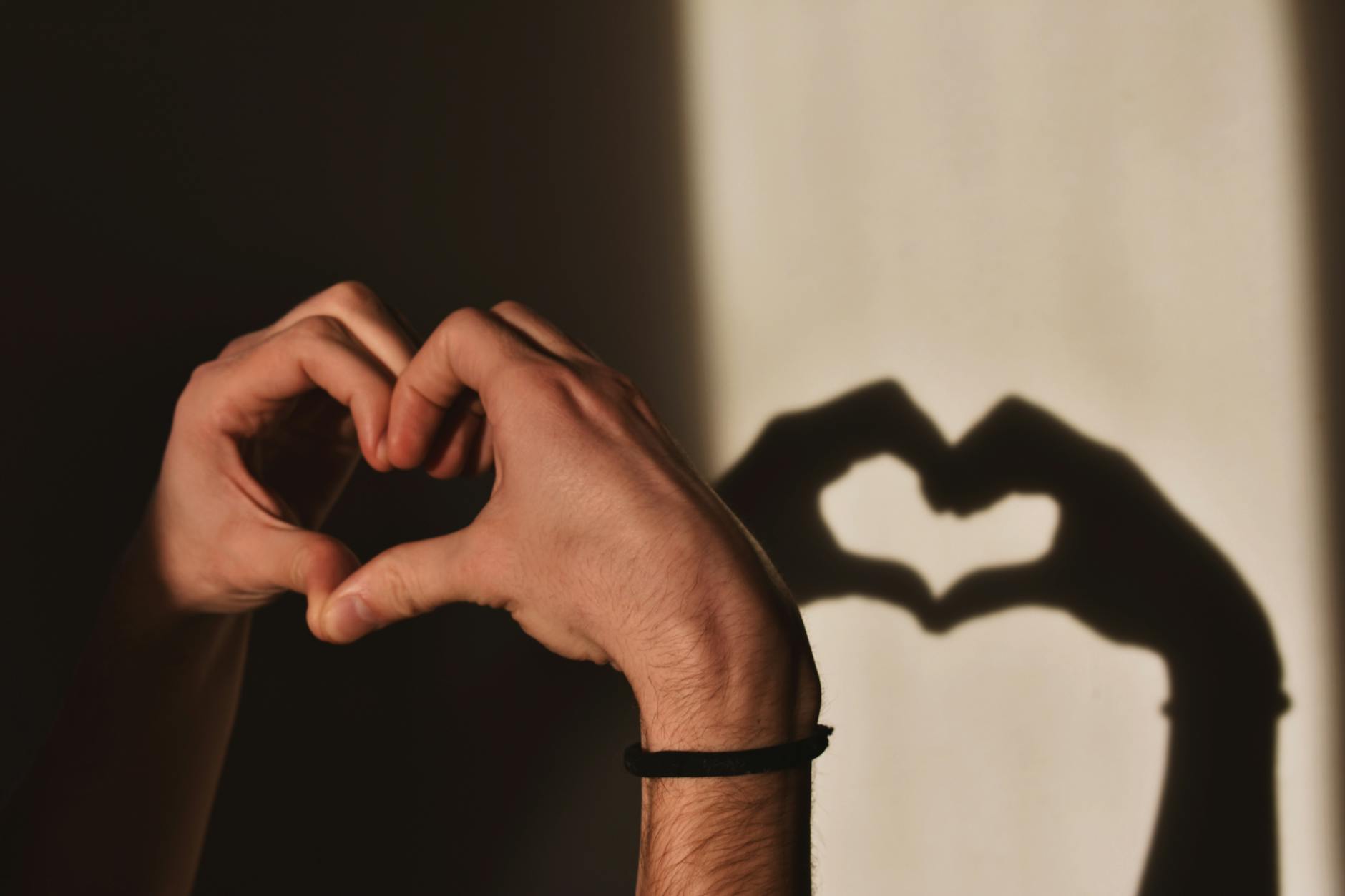 person doing heart hand gesture