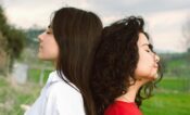 brunettes meditating together in countryside