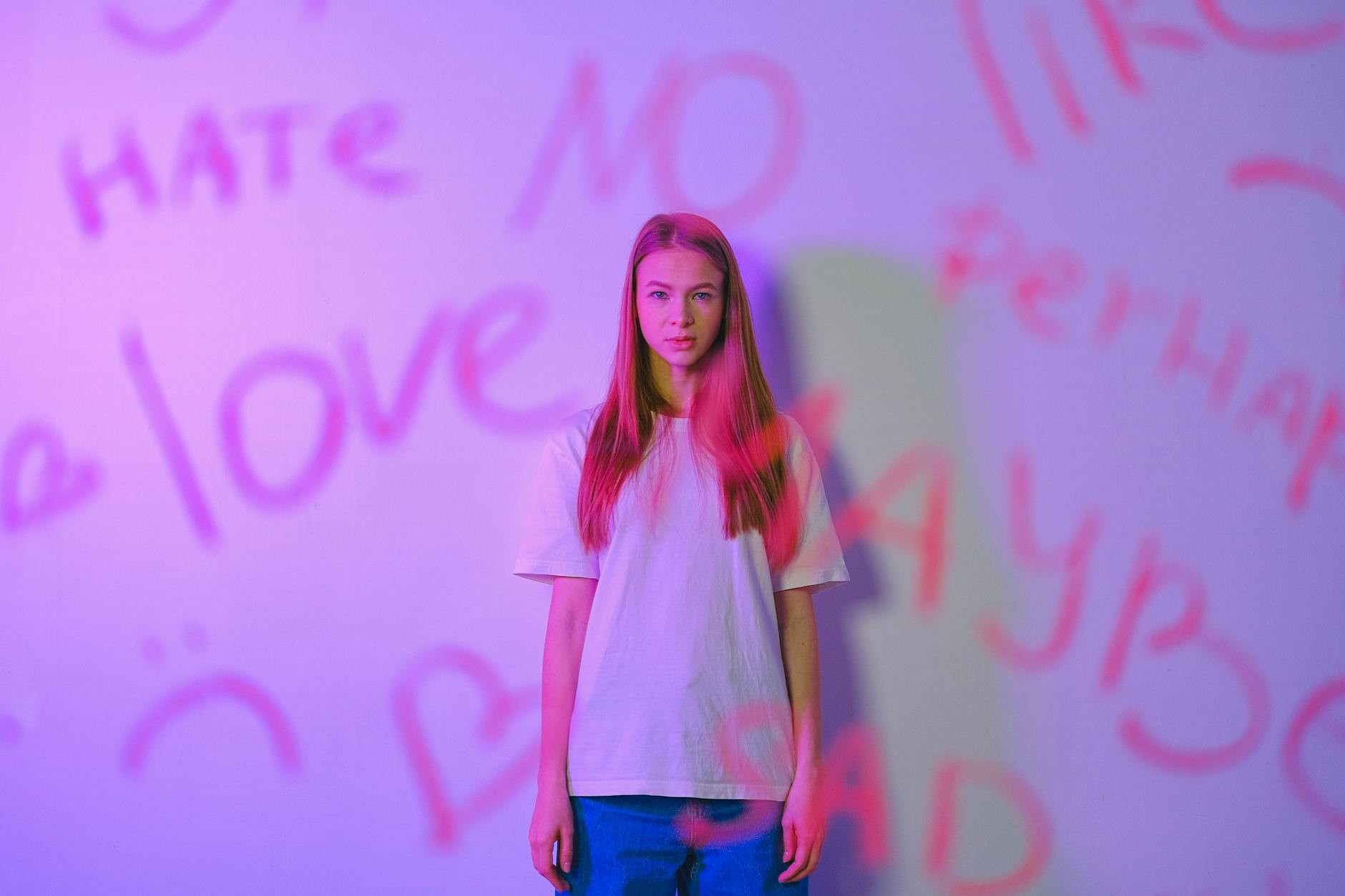 portrait of girl behind glass with words