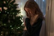 a girl in black long sleeves hugging the letter she is holding