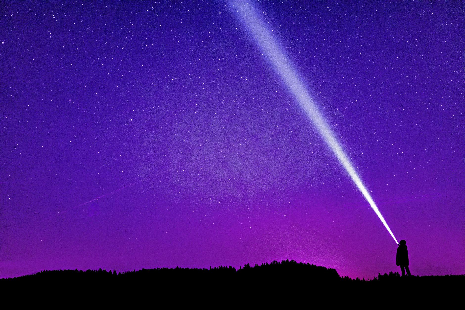 silhouette of person under blue and purple sky