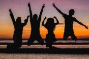 silhouette of people jumping