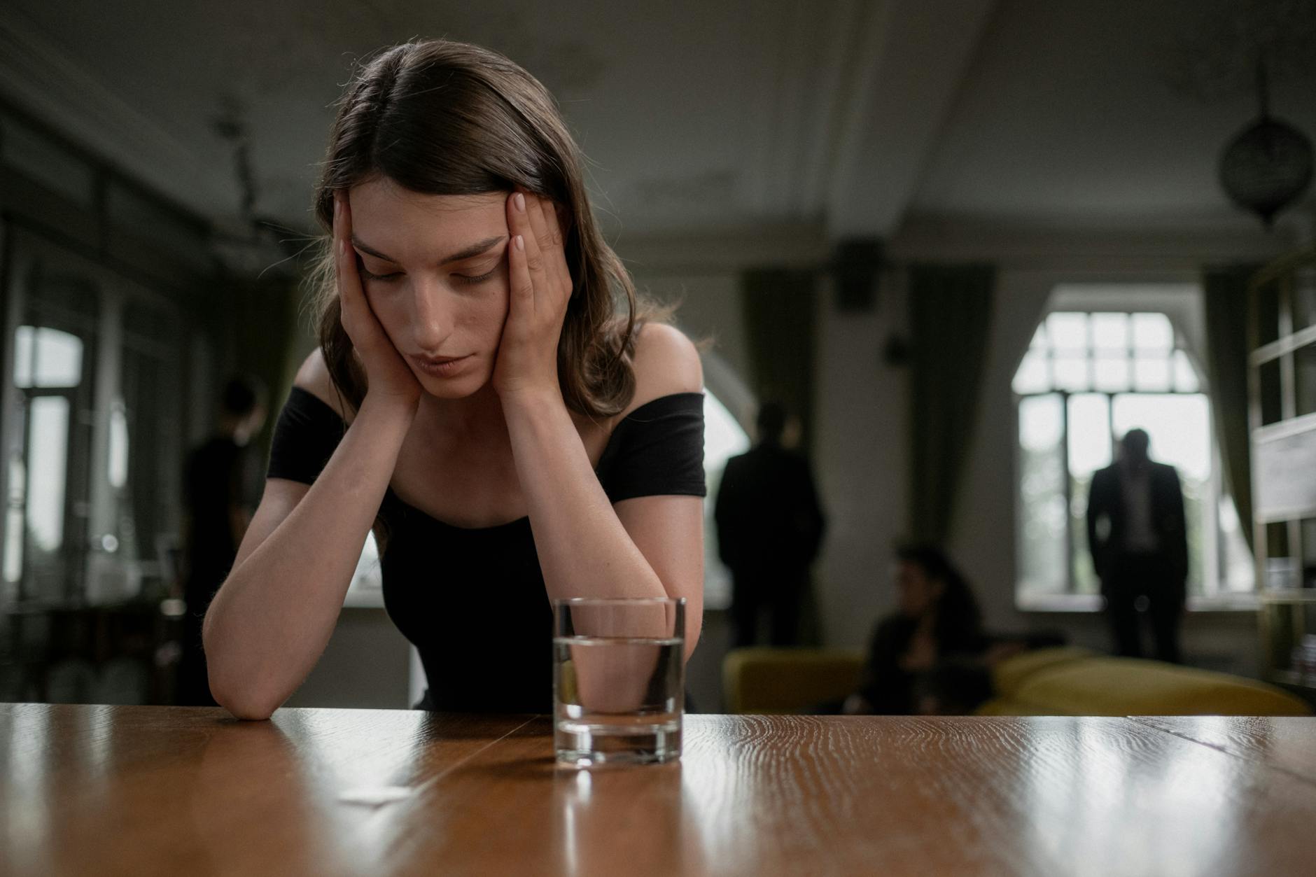 woman crying on a wooden table